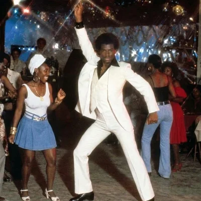 Vintage Disco - man in white suite striking a dance pose